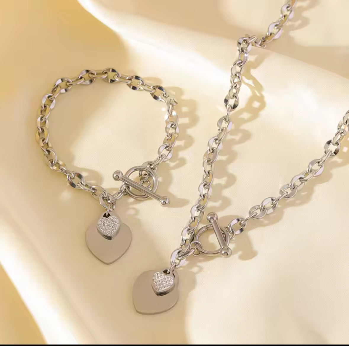stainless steel gold double heart necklace and bracelet set.
