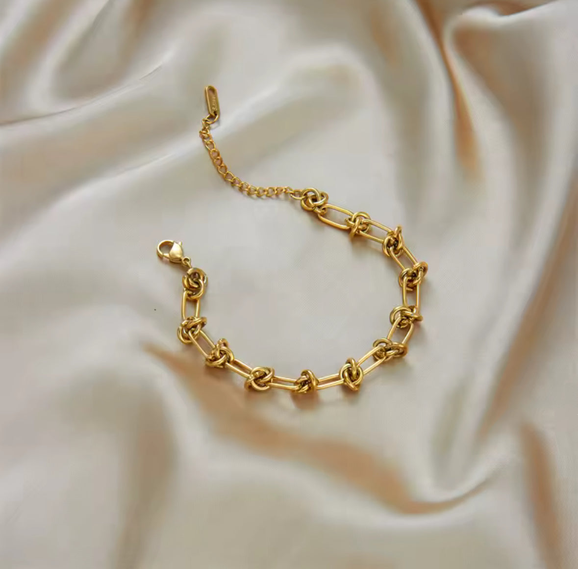 Gold twisted knot, stainless steel bracelet and necklace set.