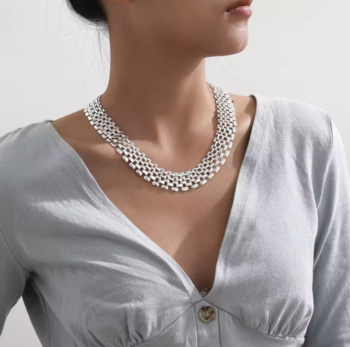 Thick silver watchband choker necklace.