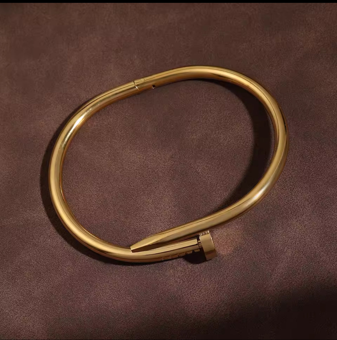 Designer-Inspired Gold Stainless Steel Nail Bracelet – Luxury Modern Bangle for Women.