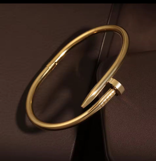 Designer-Inspired Gold Stainless Steel Nail Bracelet – Luxury Modern Bangle for Women.