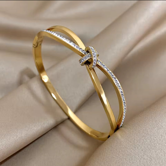 Designer inspired gold stainless steel twisted knot in laid Zircon bracelet