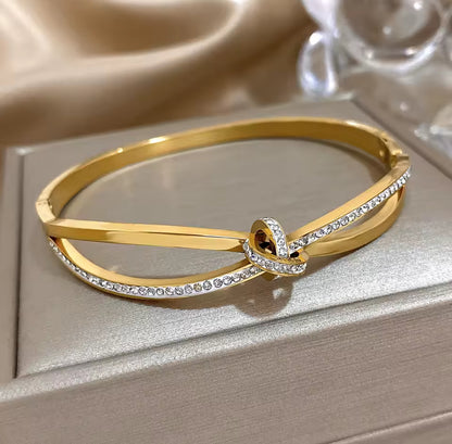 Designer inspired gold stainless steel twisted knot in laid Zircon bracelet