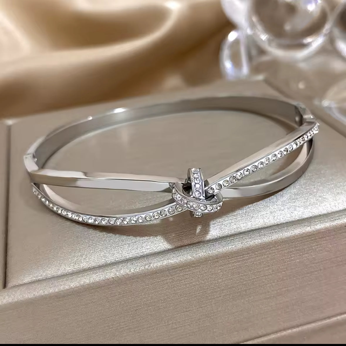 Designer Inspired  Silver Stainless Steel Twisted Knot  in laid Zircon bracelet