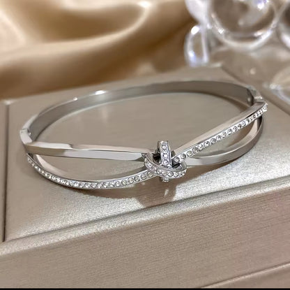 Designer Inspired  Silver Stainless Steel Twisted Knot  in laid Zircon bracelet